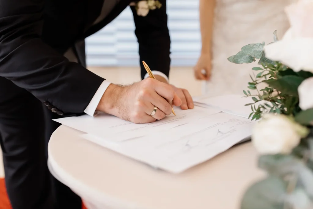 Couple signing prenuptial agreement papers